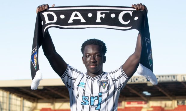 New Dunfermline Athletic signing Ephraim Yeboah holds up a DAFC scarf.