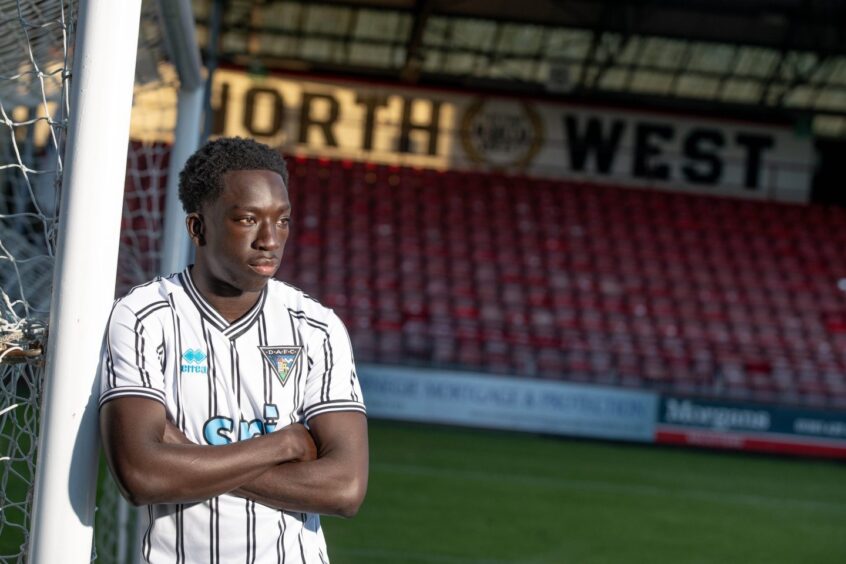 Yeboah in a Pars top, leaning against the goalpost at East End Park