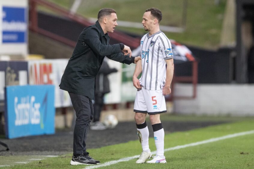 Chris Hamilton receives instructions on the touchline from new Dunfermline head coach Michael Tidser.