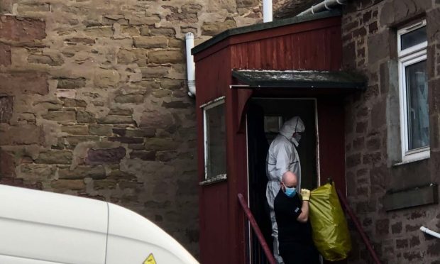 Police in white suits at a house on City Road in Dundee after a cannabis farm was found. Image: James Simpson/DC Thomson