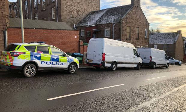 Police during the raid at the home on City Road in Dundee. Image: James Simpson/DC Thomson