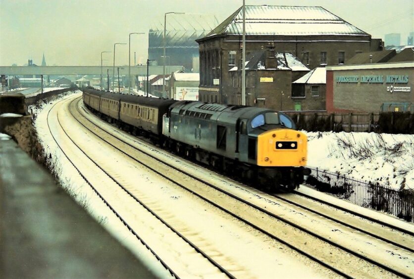 a train goes along the tracks at Dock Street in Dundee in 1979 as snow lies all around