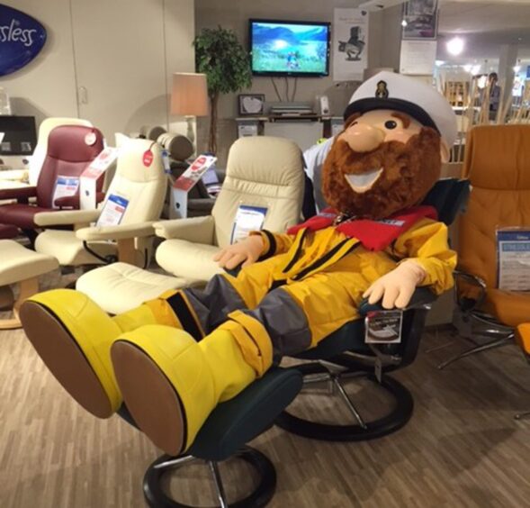 RNLI mascot Stormy Stan sits on a recliner in Gillies' Broughty Ferry shop