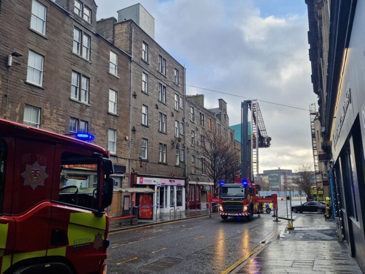 Firefighters tackling falling roof tiles on Commercial Street. 