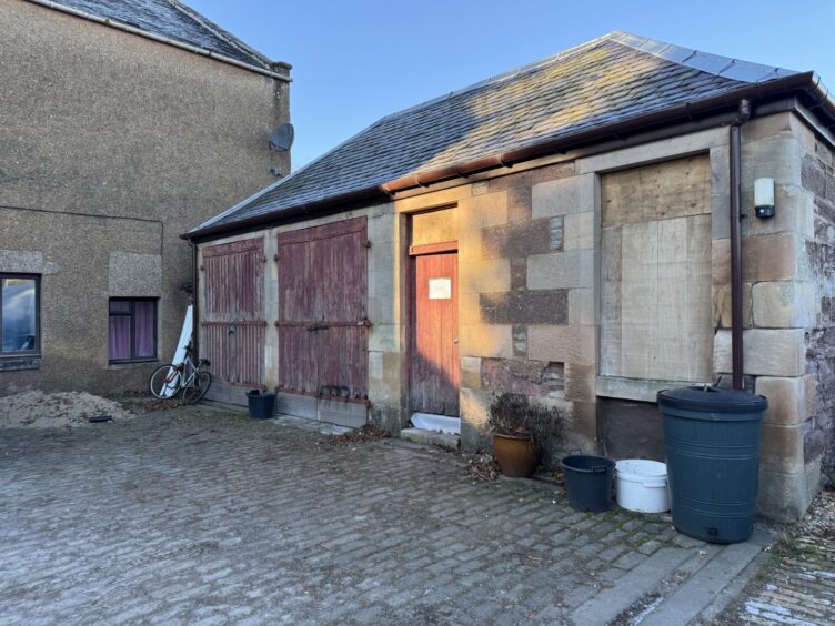 Boarded up single storey building at Rattray Community Garden