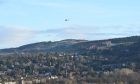 The police helicopter over Perth on Thursday as police search for John McNeil