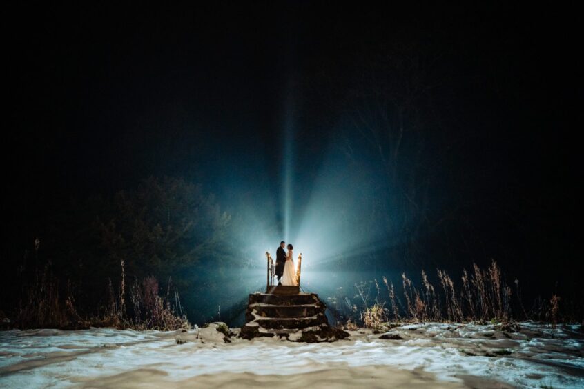 A photograph of a couple at night in the snow by the Perthshire wedding photographer sisters Eilidh Robertson and Laura Hay.