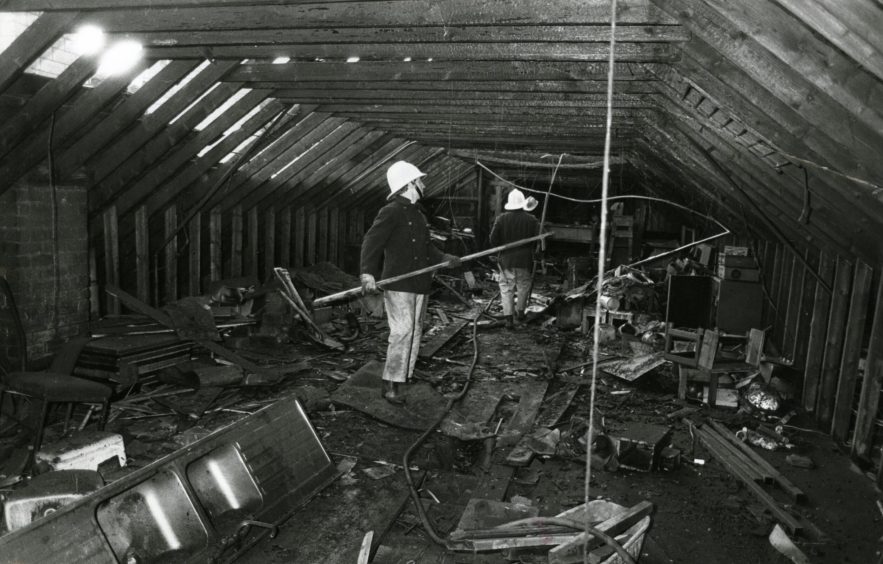 Firemen inspect the charred interior of the former Fountain disco. 