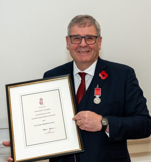 George with his British Empire Medal certificate.