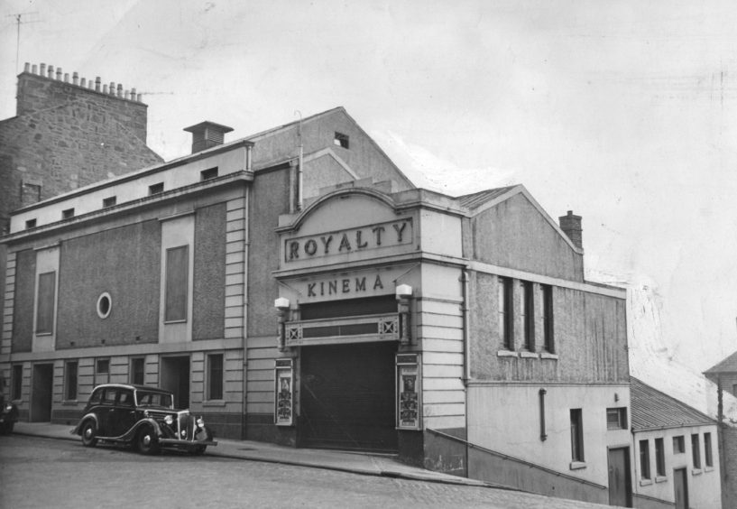 the exterior of The Royalty Kinema, Dundee, with a car parked by the kerb