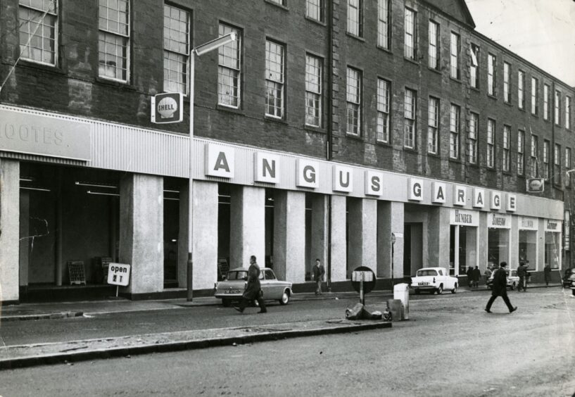 people cross the road in front of the Angus Garage in Dundee in 1965. 