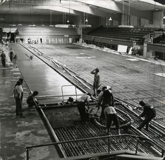 workers busy installing a new £70,000 floor at Kingsway Rink.