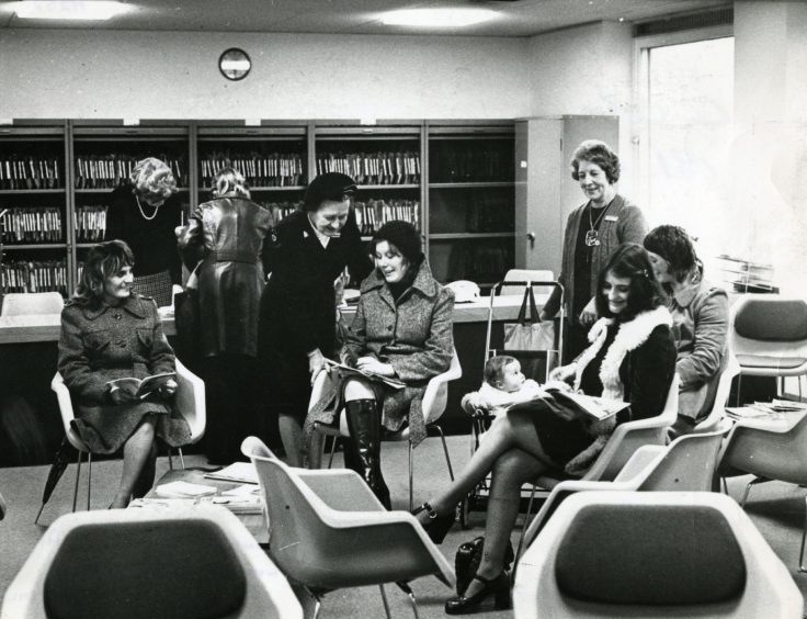 A group of volunteers at Ninewells Hospital sitting on chairs 