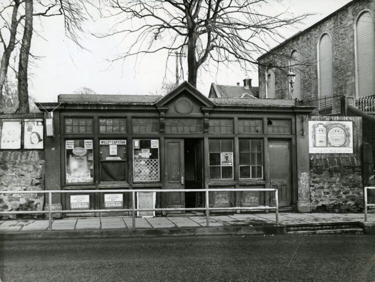 Jim Brady's shop with several posters in the window.