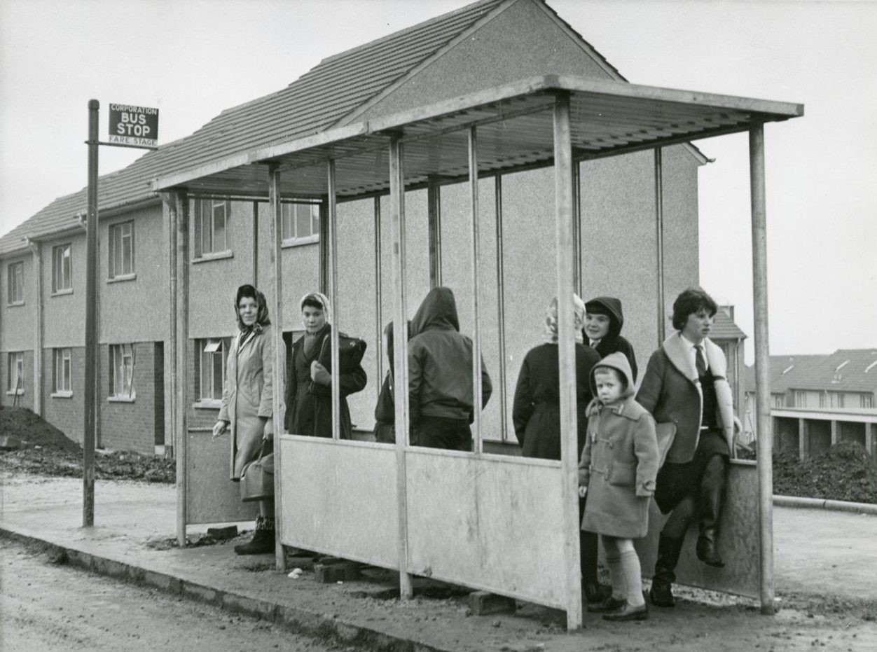 People waiting in the new bus shelter