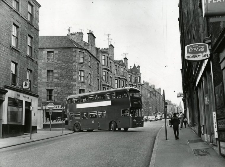 A double-decker bus negotiates the junction. 