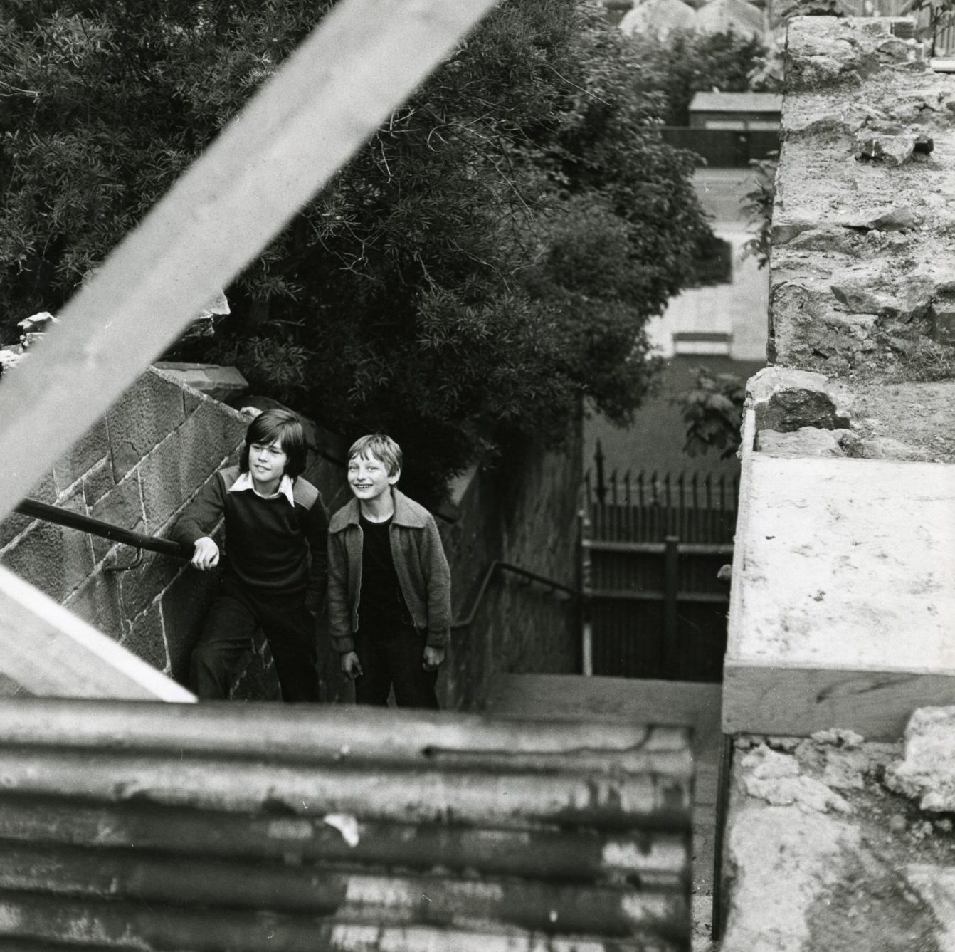 Two youngsters standing on the steps in 1977 after they were closed.