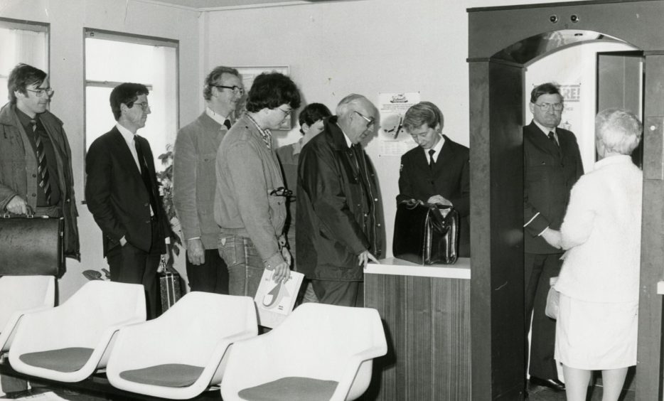 Passengers have their luggage checked by Group 4 staff at Dundee Airport in June 1985.