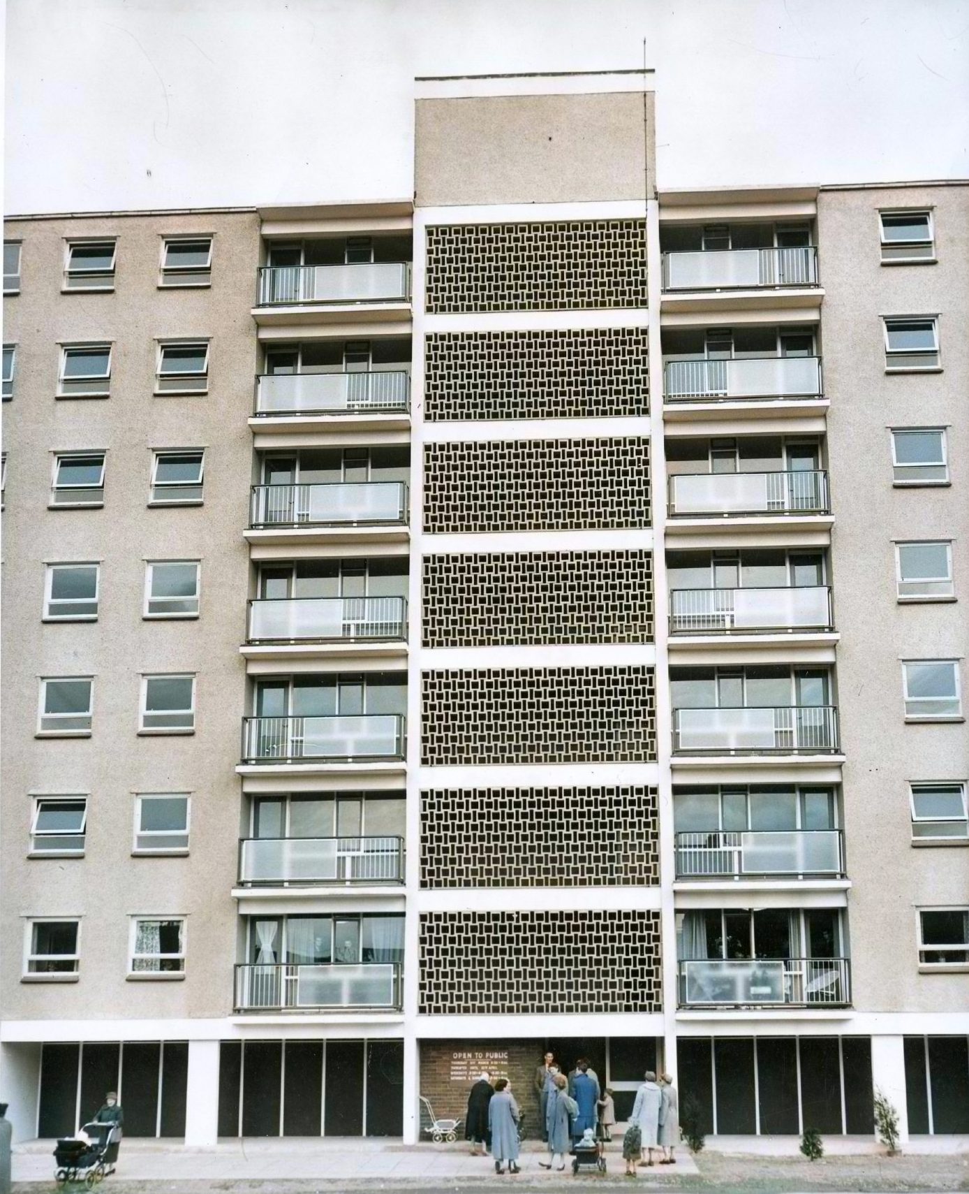 people stand at the entrance to the flats