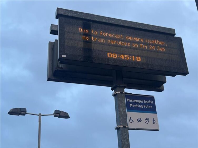 an electronic sign at a train station, stating that all trains are cancelled due to Storm Eowyn 