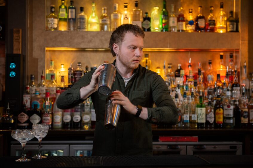 Jake Taylor making a drink in Brauch Bar.