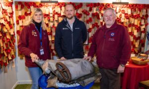 Neil White of Scottish Woodlands (centre) with Montrose Air Station Heritage Centre display coordinator Sian Brewis and chairman Stuart Archibald. Image: Jamie Dryden