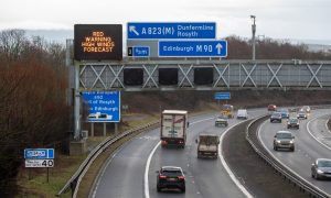 Gantry signs on the M90 tell motorists about the red weather warning in place for parts of Fife and Stirling. Image: Kenny Smith/DC Thomson