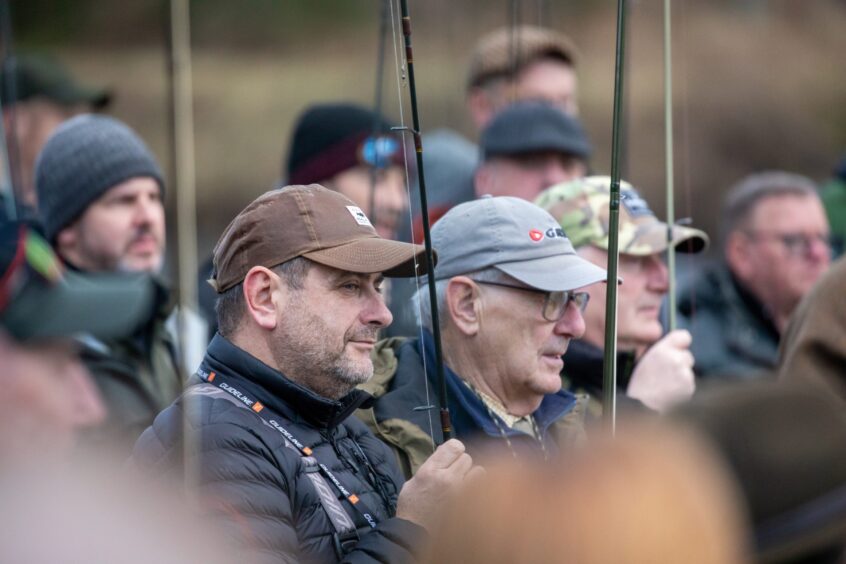 Anglers wait on the banks of the Tay at Kinclaven Bridge. 