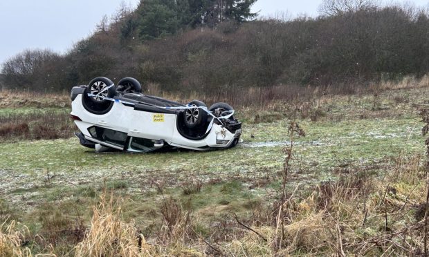 The car left the B821 at Kinglassie landing on its roof in a field.