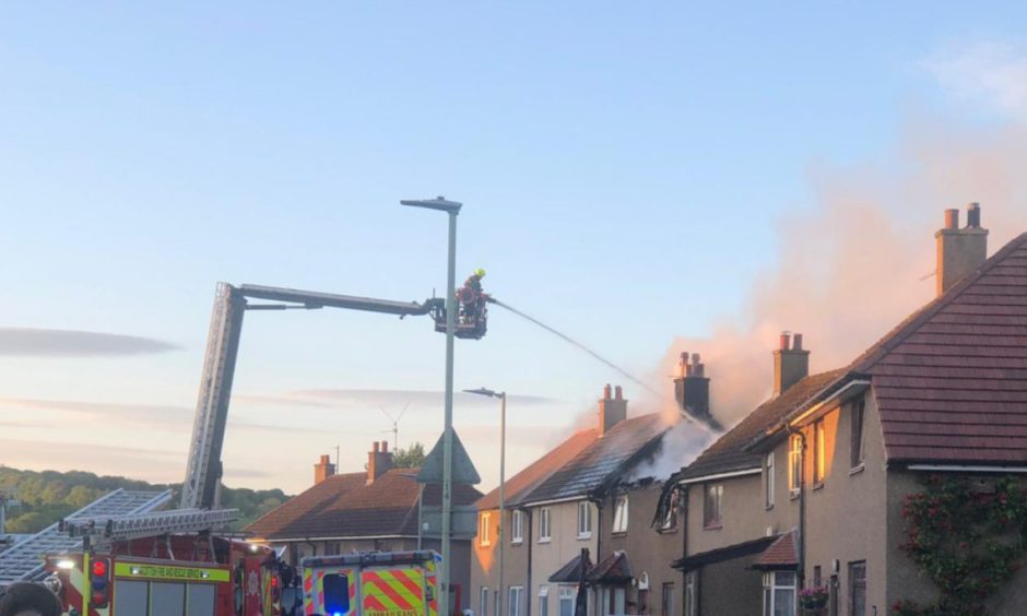 Firefighters at the scene in June.