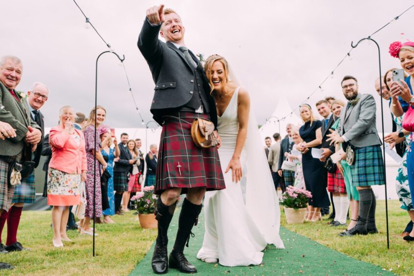 Couple laughing Perthshire wedding photographer Eilidh falls in aisle