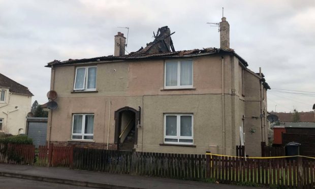 The roof of the block of homes on Letham Terrace in Leven has been destroyed. Image: James Simpson/DC Thomson