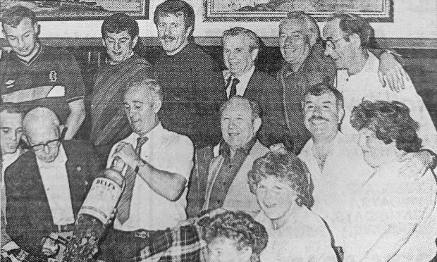 people watch a bottle smash at Sandy's Bar for Lochee pensioners in July 1986.