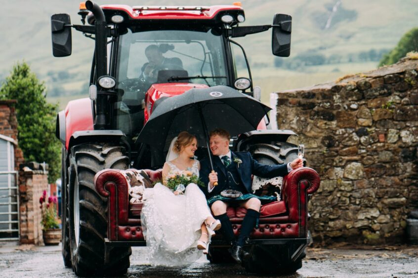 Couple on sofa in tractor in an image by the Perthshire wedding photographer Eilidh Robertson Photography