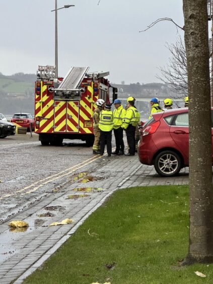 Emergency services workers beside a fire engine on a Dundee street during Storm Eowyn