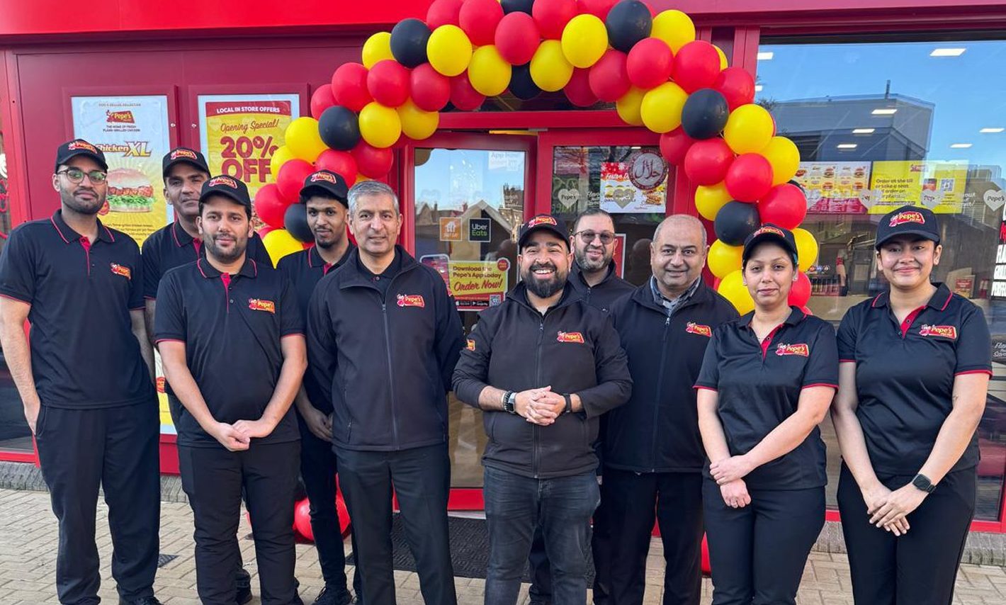 Naveed Sarwar outside the new store with staff. Image: Supplied