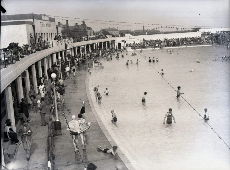 people look on from a gallery as bathers use Arbroath outdoor pool