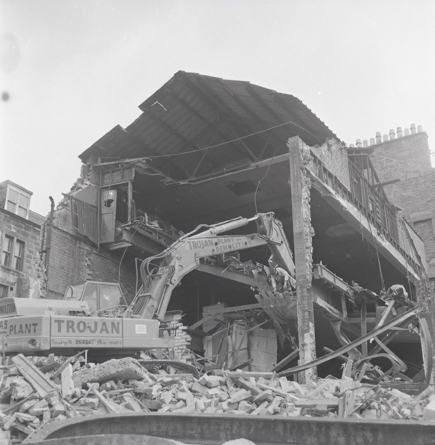 the exposed insides of the Royalty Kinema cinema as a digger pulls the building down