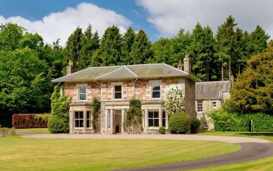 Shanwell House, a two-storey Georgian manor with neat lawn.
