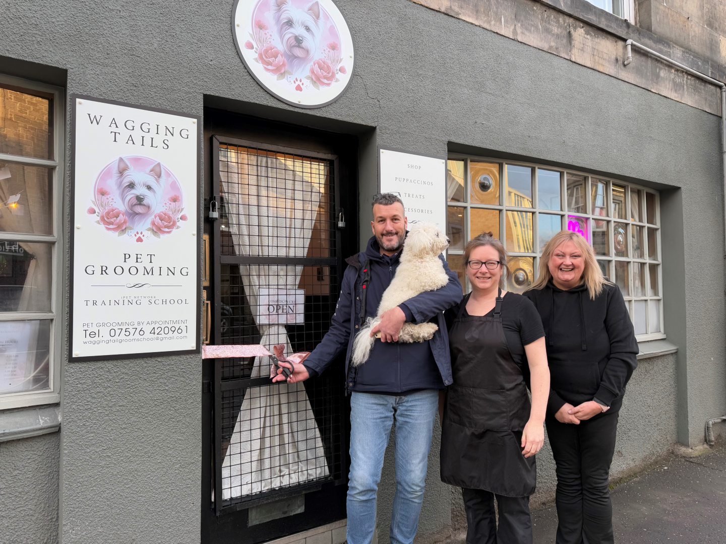 The first customer cut the ribbon outside.