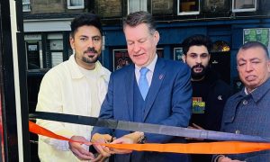 Murdo Fraser cuts a ribbon to open Punjabi Cuisine on Perth's North Methven Street.