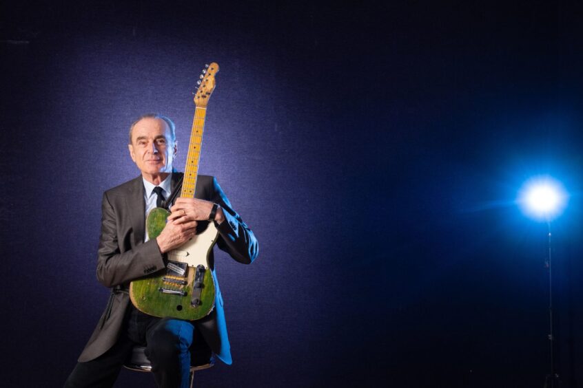 Francis Rossi of Status Quo holding a guitar