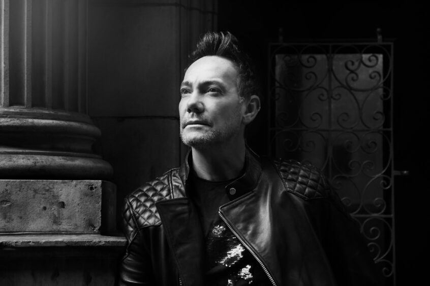 a black and white press shot of Craig Revel Horwood