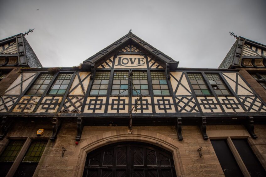 Loves building exterior, featuring distinctive black and white timberwork and the name Love on a gable.