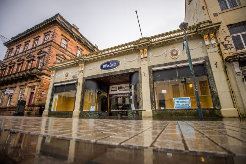 EMpty department store building, with Bliss Beds sign still above door.