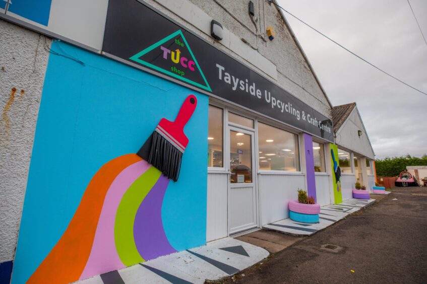 Tayside Upcycling and Craft Centre exterior, a large white showroom building with colourful paintbrush logo on wall