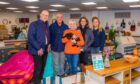 John Swinney with group of people inside Tayside Upcycling and Craft Centre showroom filled with upcycled furniture