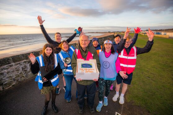 West Links parkrun event director Arthur Grant with the birthday cake and other key figures in the anniversary event. Image: Steve MacDougall/DC Thomson