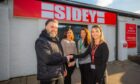 Four people standing in front of Sideys glazing showroom in Perth.