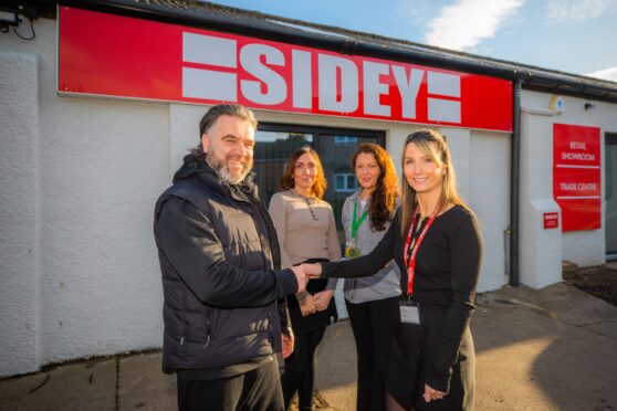 Four people standing in front of Sideys glazing showroom in Perth.